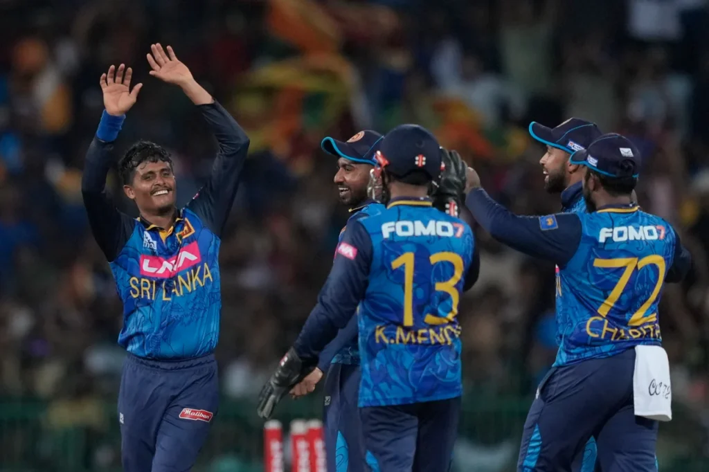 Sri Lanka cricket team celebrating wicket with FOMO7 logo displayed on the back of team jerseys as sponsor.