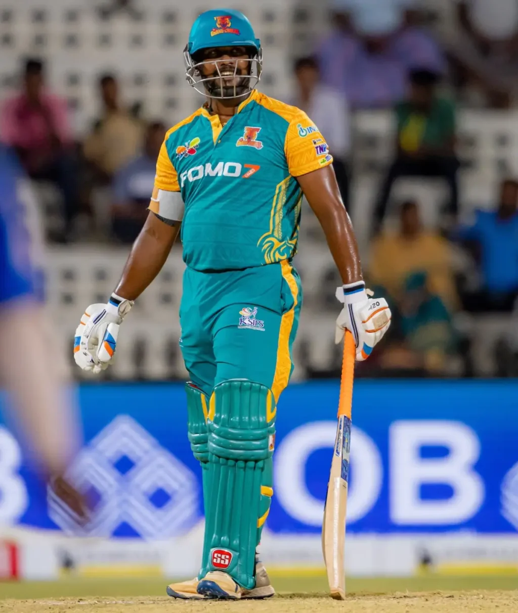 FOMO7 logo on Trichy Grand Cholas cricket jersey worn by player during a match, showing principal sponsorship branding.